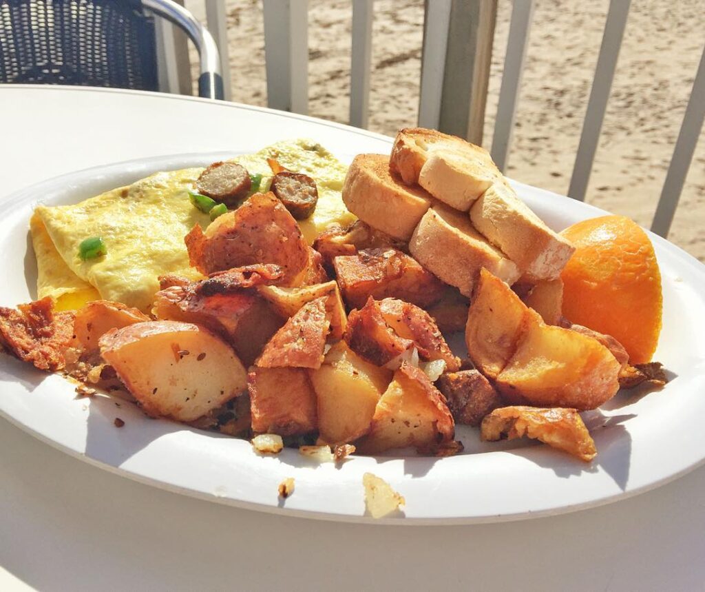 Sausage and bacon omelette with homefries from Benny's on the Beach in Lake Worth