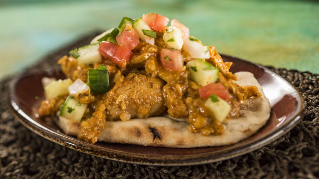 Korma Chicken with Cucumber Tomato Salad, Almonds, Cashews, and Warm Naan Bread from the Epcot International Food & Wine Festival