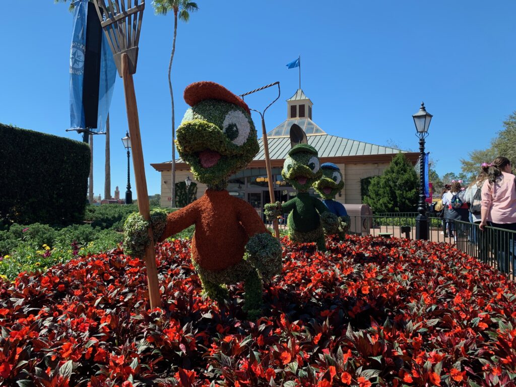 Huey, Duey and Luey are working in the garden at Showcase Plaza between Port of Entry and Disney Traders